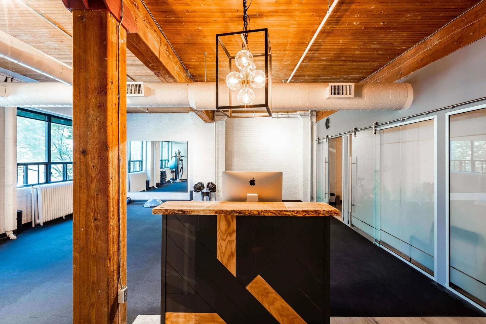 PhysioDNA clinic reception with private glass treatment rooms
