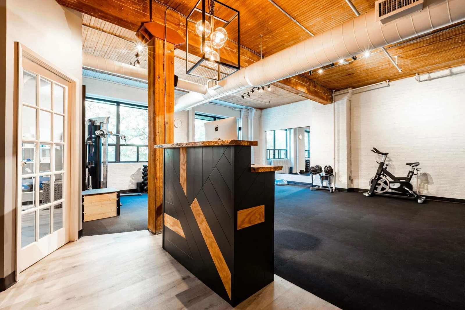 PhysioDNA open rehab floor with strength and conditioning equipment