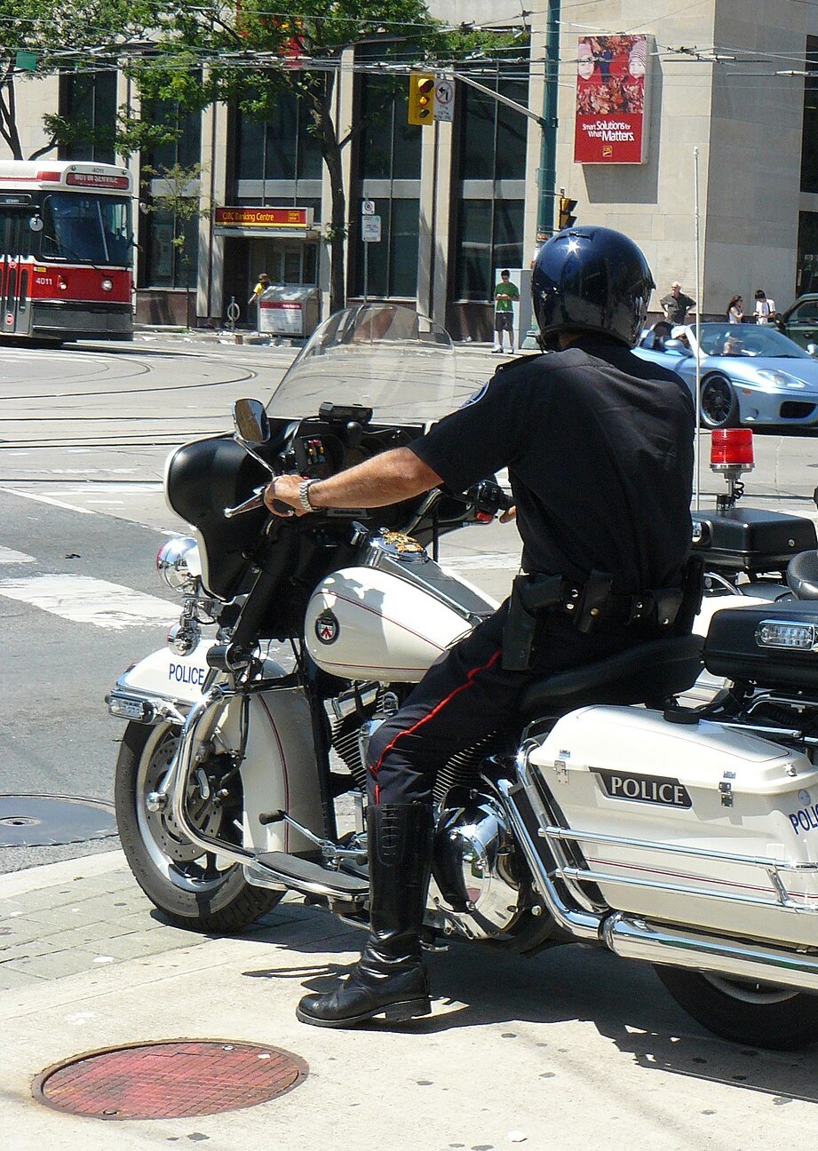 Toronto Police motorcycle officer from behind at a downtown intersection